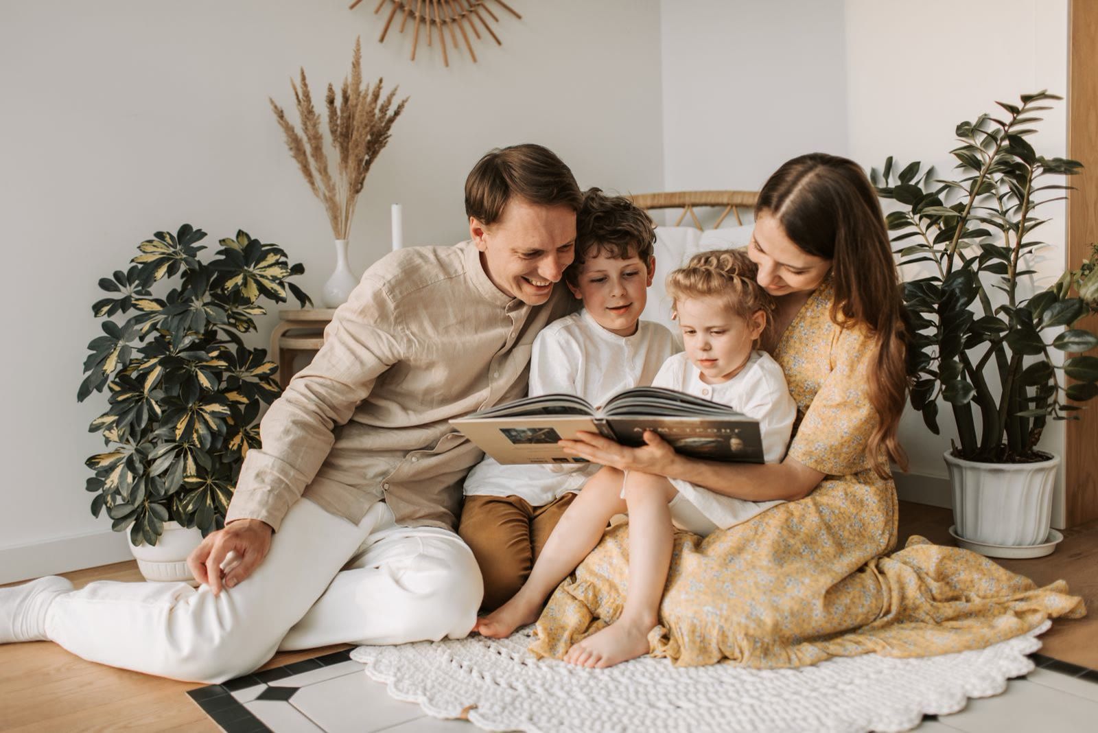 A family reading together in a bright living room